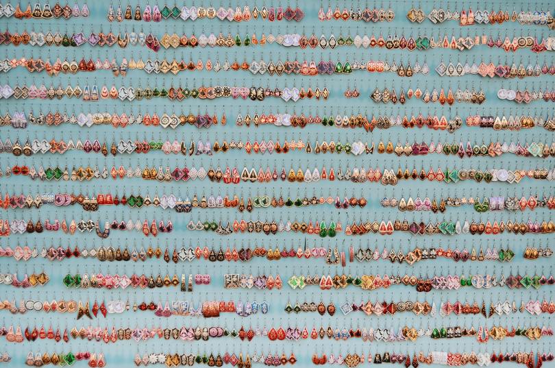 a huge display of drop earrings in different colors