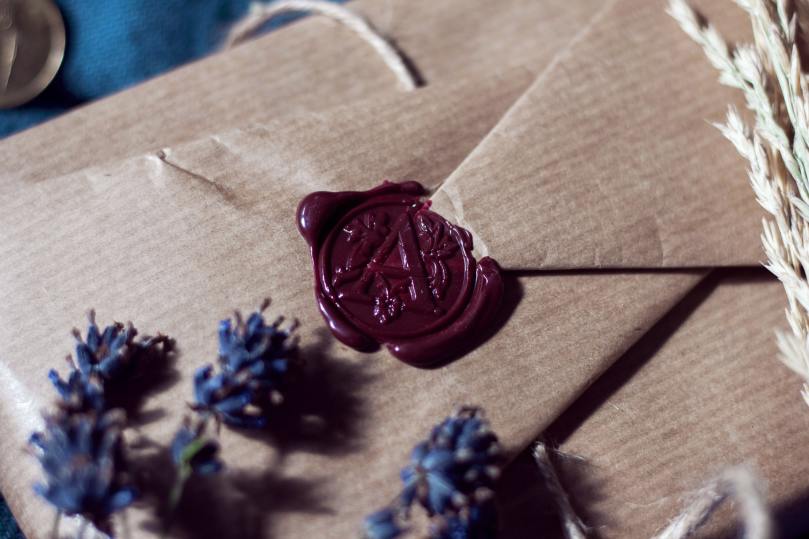 plum wax seal in brown packaging with lavender flowers